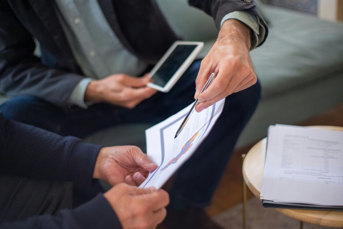 Business advisors comparing loan documents and financial data